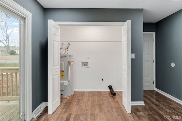 laundry room featuring washer hookup, dark hardwood / wood-style floors, hookup for an electric dryer, and electric water heater