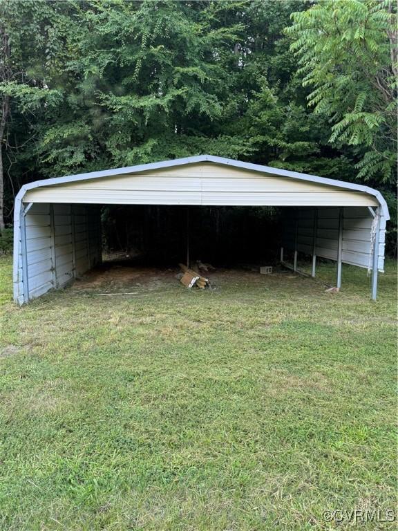 exterior space featuring a carport and a yard