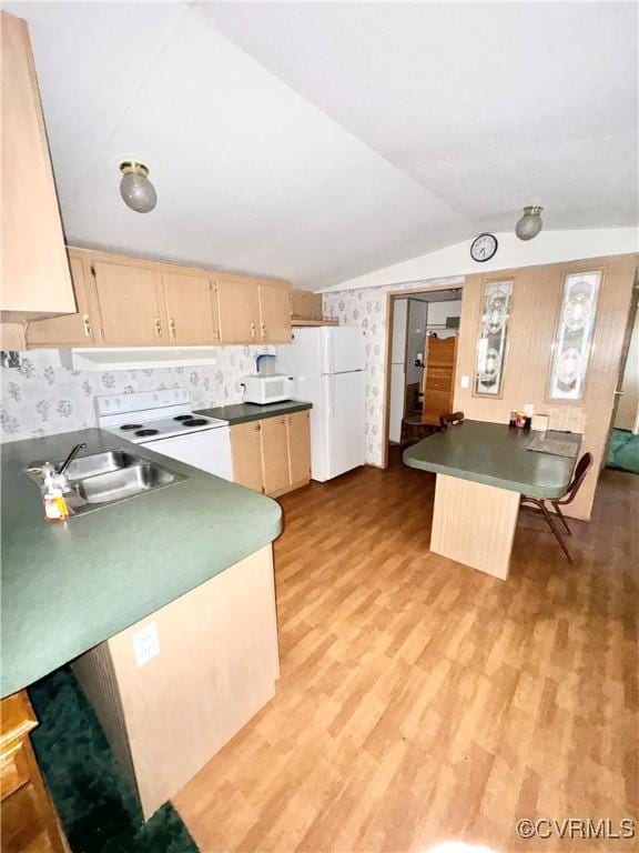 kitchen with a breakfast bar, white appliances, sink, light brown cabinets, and light hardwood / wood-style flooring