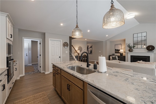 kitchen featuring white cabinets, appliances with stainless steel finishes, hanging light fixtures, and sink