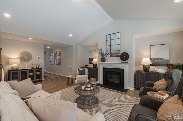 living room featuring hardwood / wood-style floors and vaulted ceiling