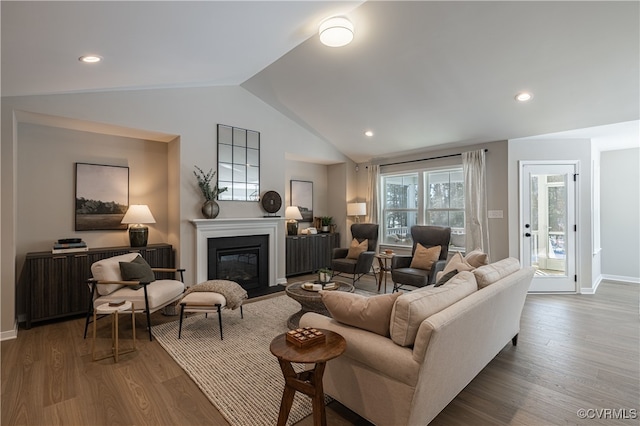 living room featuring hardwood / wood-style floors and vaulted ceiling