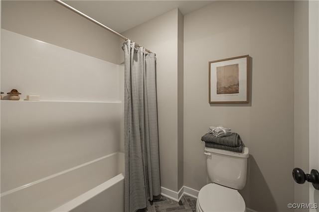 bathroom with shower / bath combo and toilet