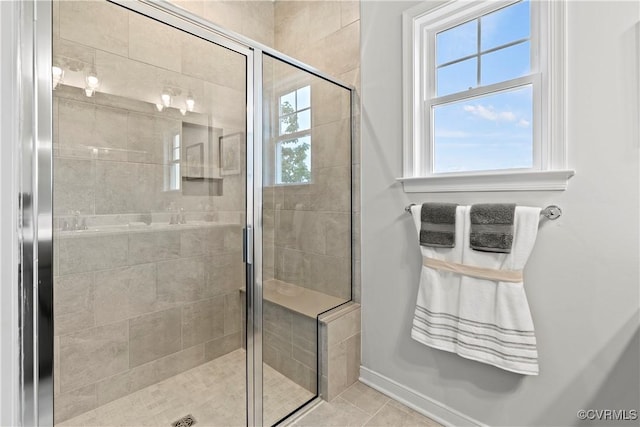 bathroom featuring tile patterned flooring and an enclosed shower