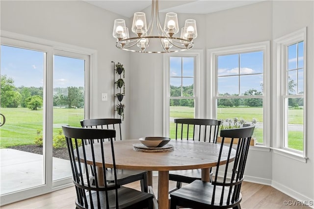 dining space featuring a chandelier and light wood-type flooring