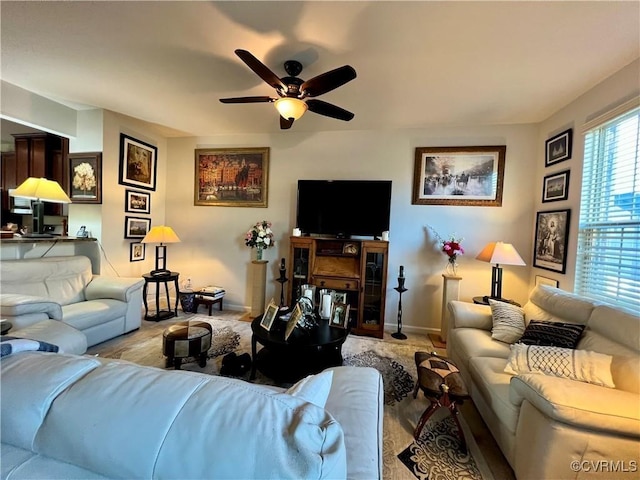 carpeted living room with ceiling fan