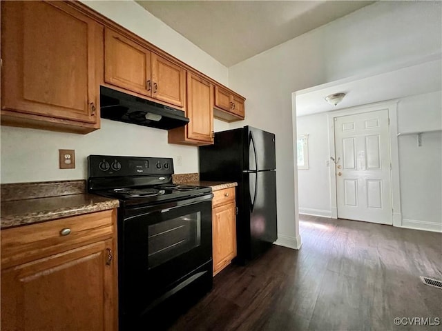 kitchen with dark wood-type flooring and black appliances