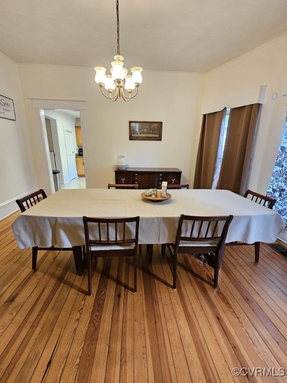dining area featuring a chandelier and light wood-type flooring