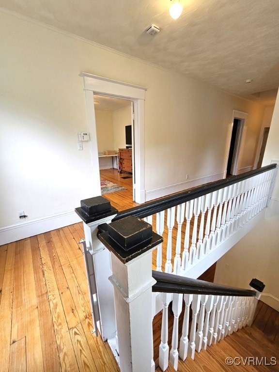 stairs featuring hardwood / wood-style floors and baseboards