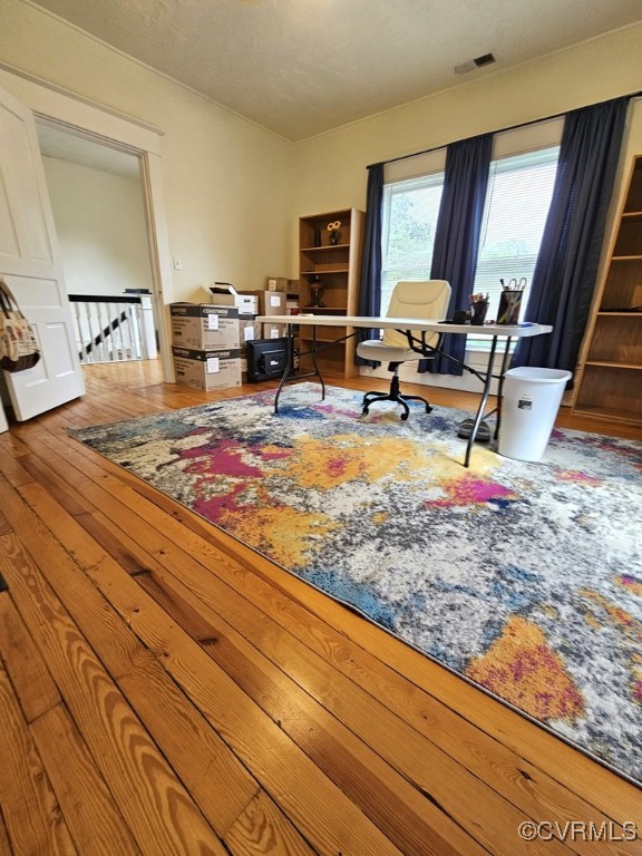 office featuring wood-type flooring and visible vents