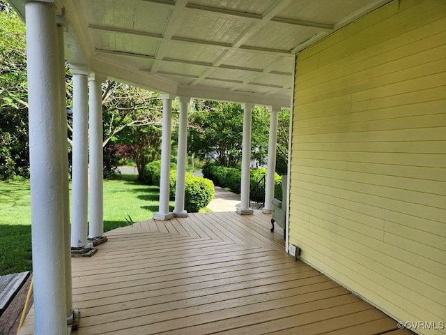 deck with a lawn and covered porch