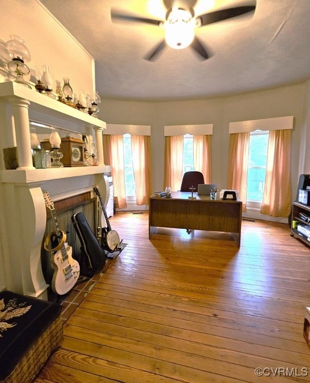 bedroom featuring wood-type flooring and a fireplace