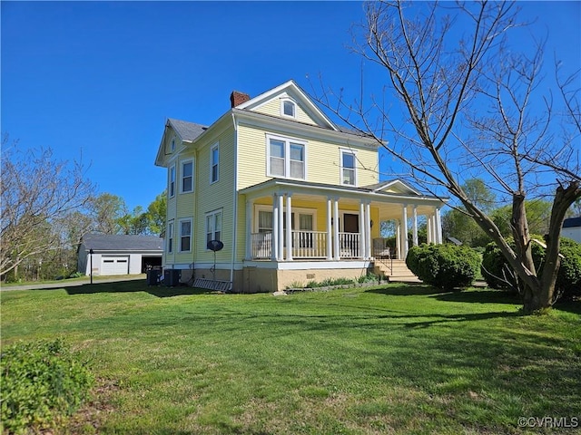 back of house featuring a chimney, a yard, a garage, and covered porch