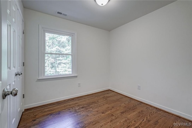 spare room with dark wood-type flooring