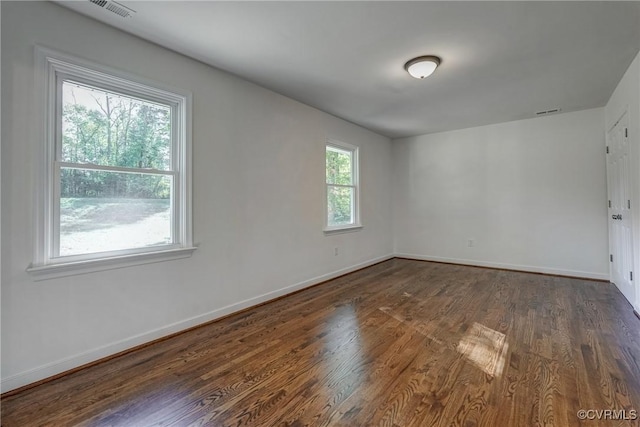 spare room featuring dark hardwood / wood-style floors