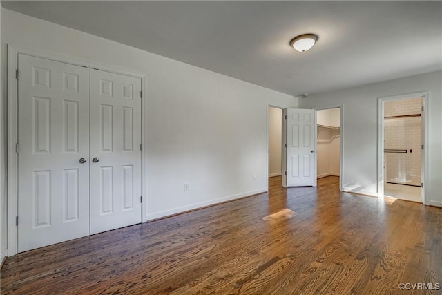 unfurnished bedroom featuring dark hardwood / wood-style flooring