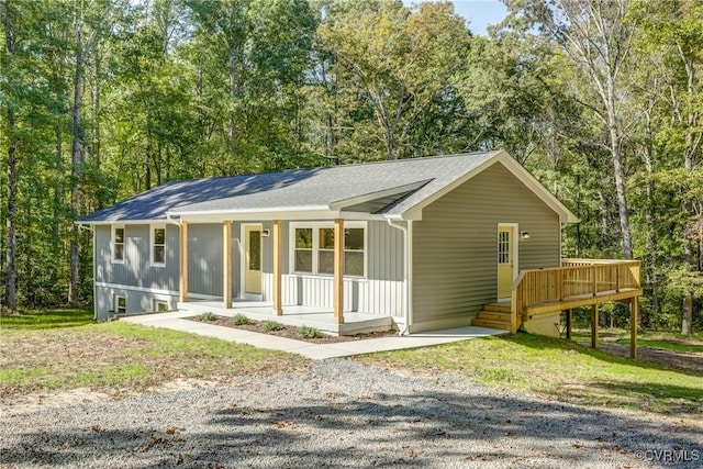 single story home with a wooden deck and covered porch