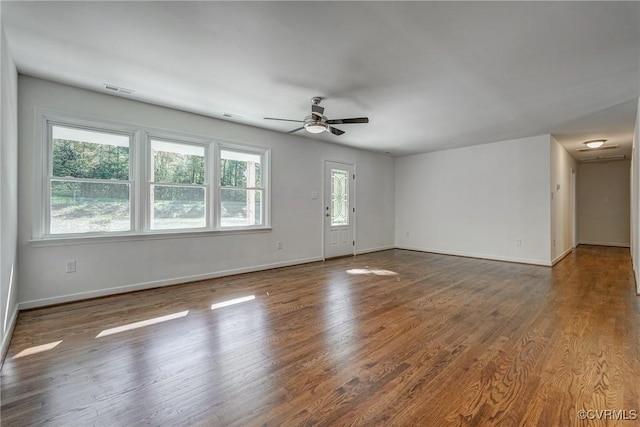 empty room featuring hardwood / wood-style floors and ceiling fan