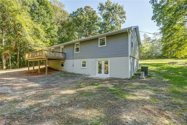 back of house with a lawn, french doors, cooling unit, and a deck