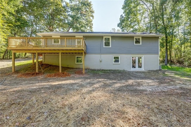 rear view of property featuring french doors and a deck