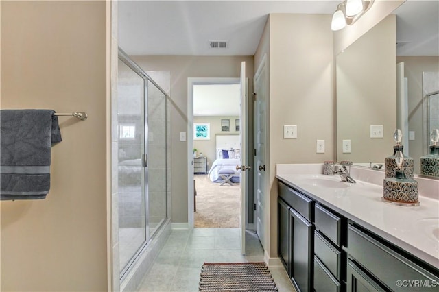 bathroom with tile patterned flooring, vanity, and a shower with shower door