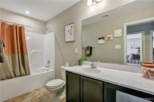 full bathroom featuring shower / tub combo with curtain, vanity, and toilet