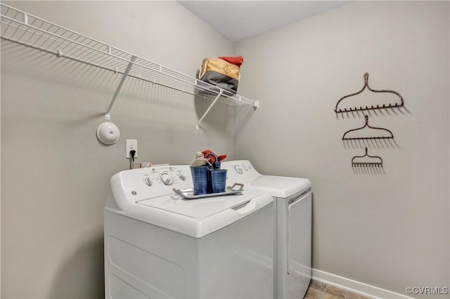 washroom with washing machine and clothes dryer