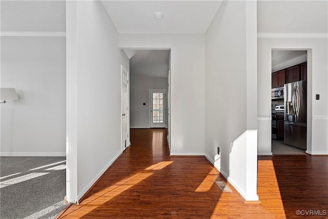 hallway with dark hardwood / wood-style floors and ornamental molding