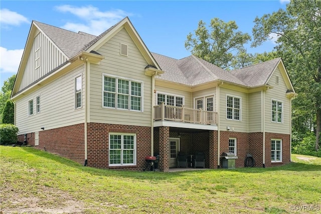 back of property featuring a yard and a wooden deck