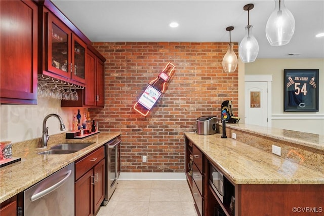 kitchen with stainless steel dishwasher, light stone counters, sink, and hanging light fixtures