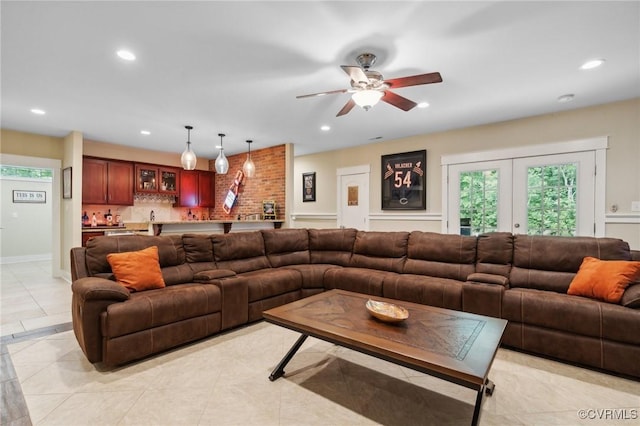 living room featuring ceiling fan, light tile patterned floors, and french doors