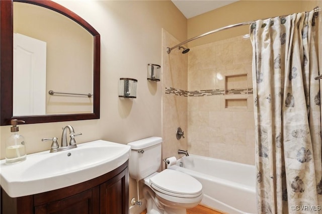 full bathroom featuring shower / bathtub combination with curtain, vanity, and toilet