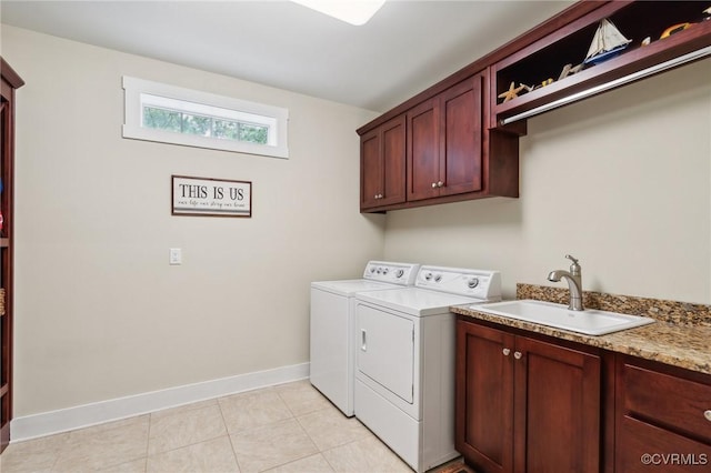 washroom featuring light tile patterned flooring, cabinets, separate washer and dryer, and sink