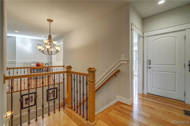 entrance foyer featuring hardwood / wood-style floors and a notable chandelier