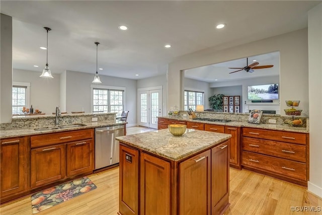 kitchen featuring french doors, sink, hanging light fixtures, kitchen peninsula, and stainless steel appliances