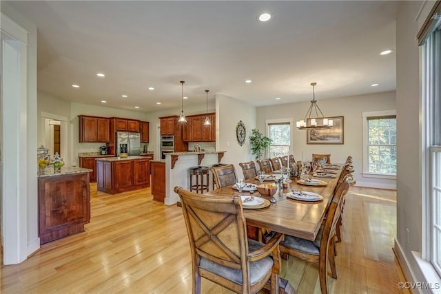 dining room featuring light hardwood / wood-style floors and a chandelier