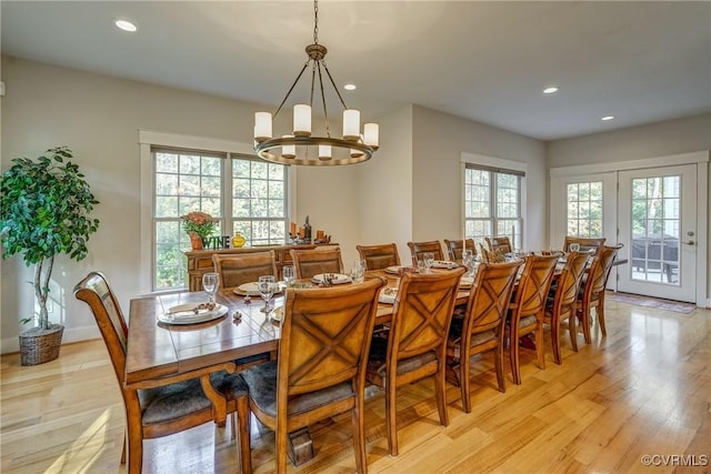 dining space featuring plenty of natural light, a chandelier, and light hardwood / wood-style floors