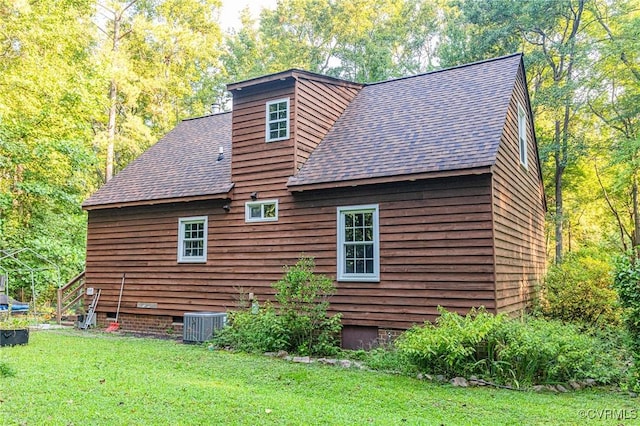 view of home's exterior featuring a lawn and central AC unit