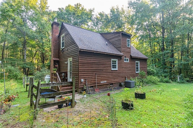 view of side of home featuring a yard and cooling unit