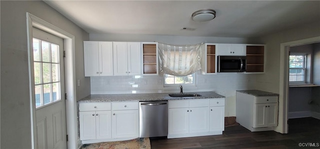 kitchen with dishwasher, white cabinets, and a healthy amount of sunlight