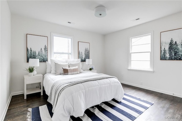 bedroom with dark wood-type flooring