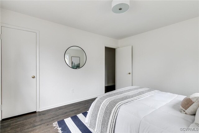 bedroom with dark hardwood / wood-style flooring