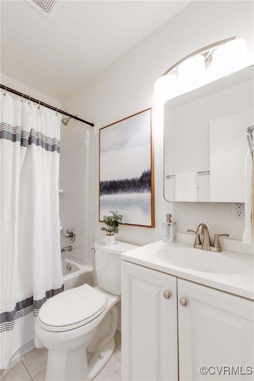 full bathroom featuring tile patterned flooring, vanity, shower / bath combo, and toilet