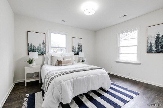 bedroom with dark wood-type flooring