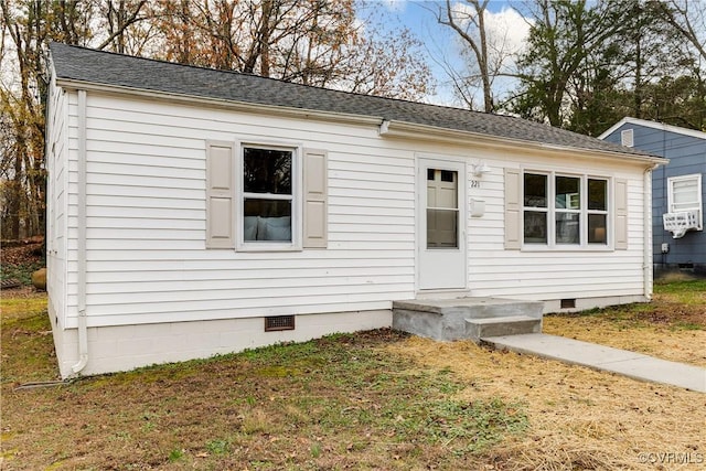 view of front of home with cooling unit and a front lawn