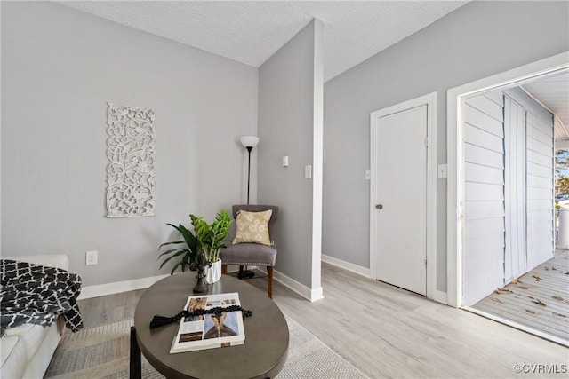 sitting room featuring a textured ceiling and light hardwood / wood-style flooring