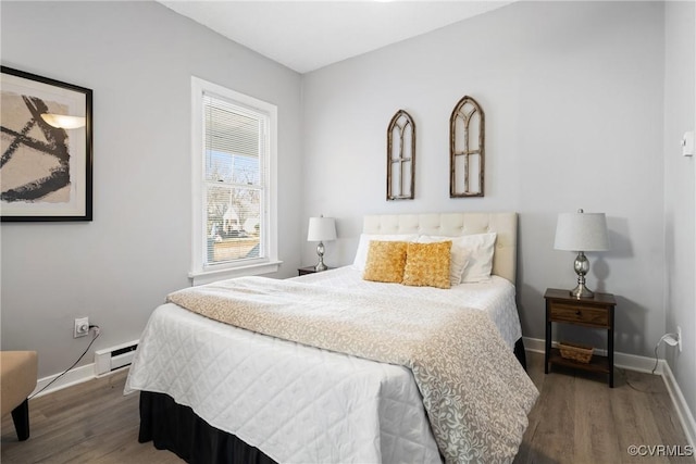 bedroom with wood-type flooring and a baseboard radiator