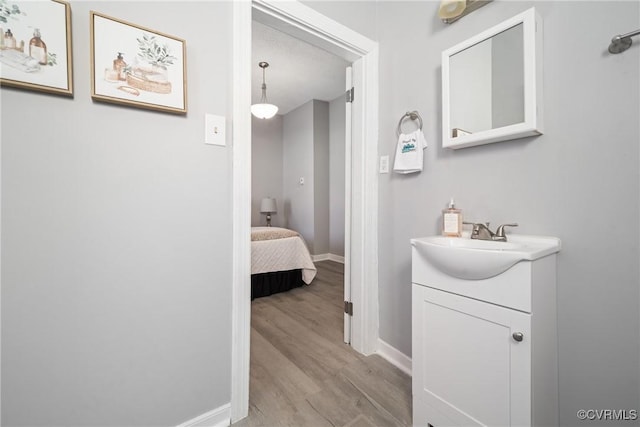 bathroom featuring hardwood / wood-style floors and vanity