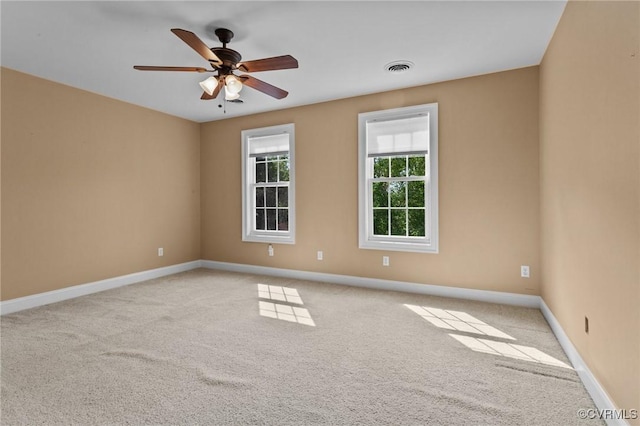 carpeted spare room with ceiling fan