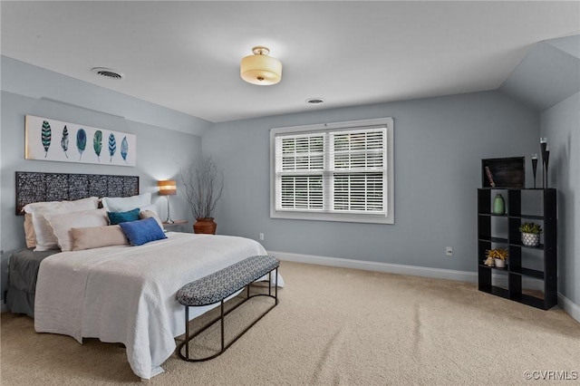 carpeted bedroom with lofted ceiling